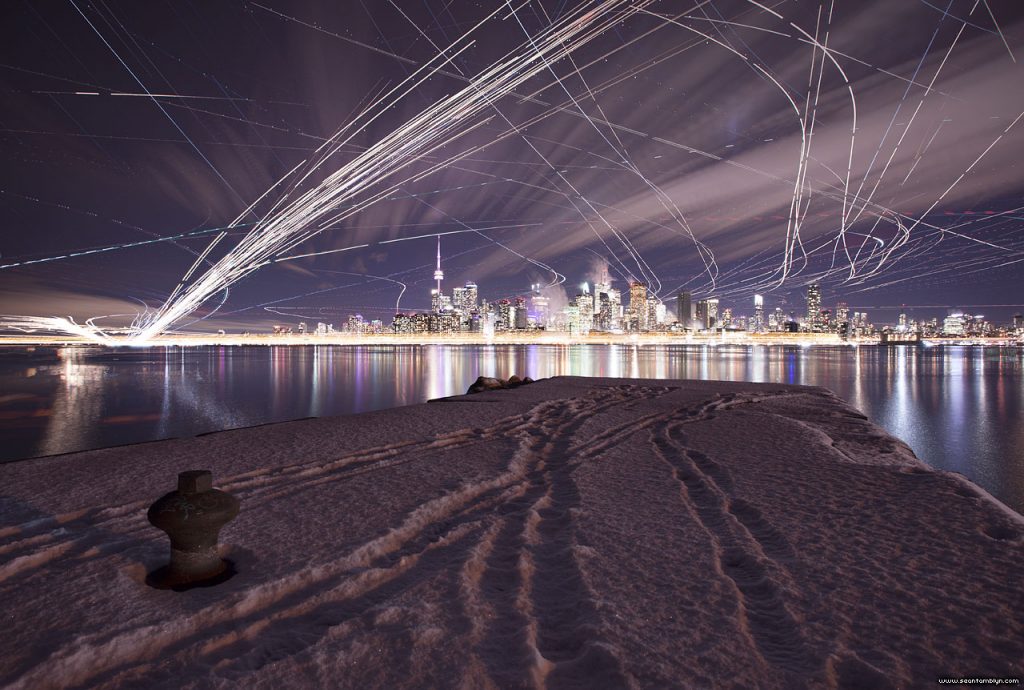Long exposure aircraft trails over Toronto skyline, Wards Island, Toronto Islands