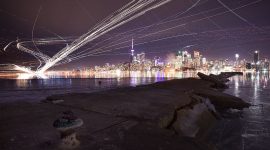 Long exposure aircraft trails over Toronto skyline, Ward's Island, Toronto Island
