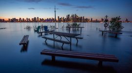 Flooded picnic area fire pit in front of Toronto skyline, Olympic Island, Toronto Islands